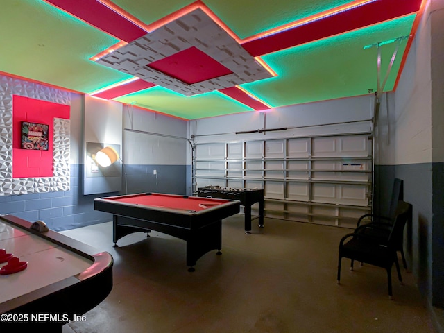 playroom with concrete floors and pool table