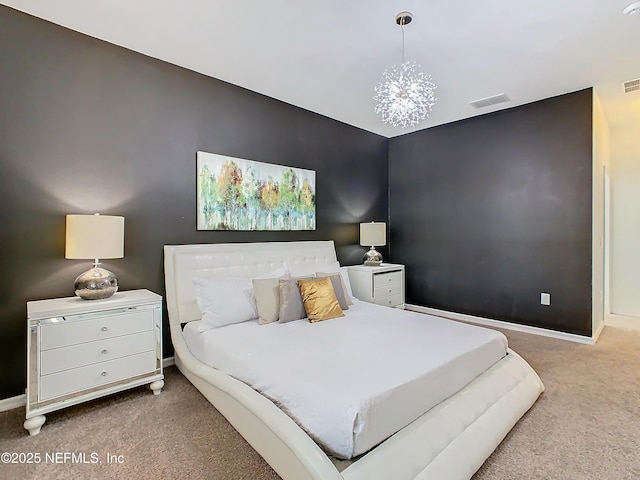 bedroom with a notable chandelier and carpet floors