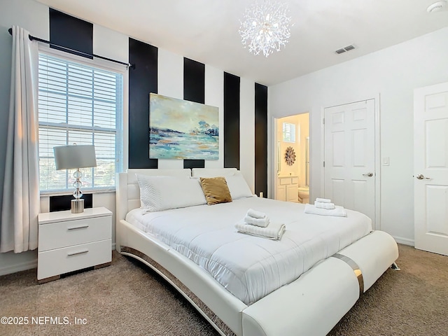 carpeted bedroom featuring ensuite bathroom and a chandelier