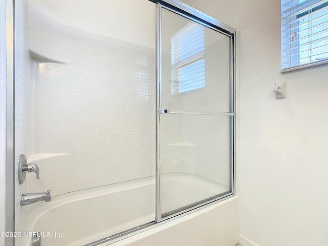 bathroom featuring a healthy amount of sunlight and enclosed tub / shower combo