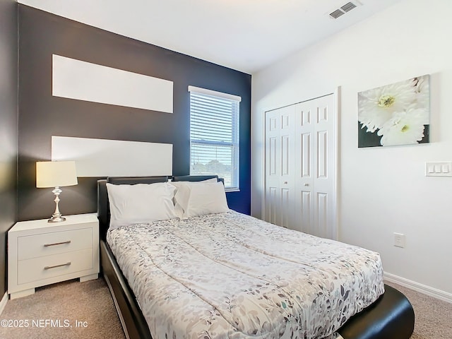 bedroom with a closet and light colored carpet