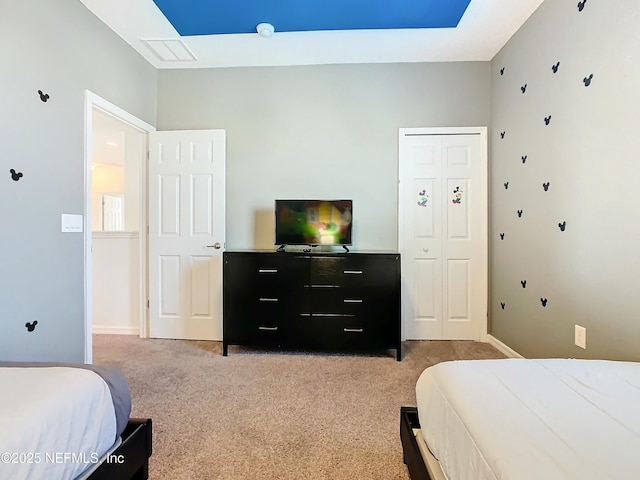 bedroom featuring light colored carpet and a closet