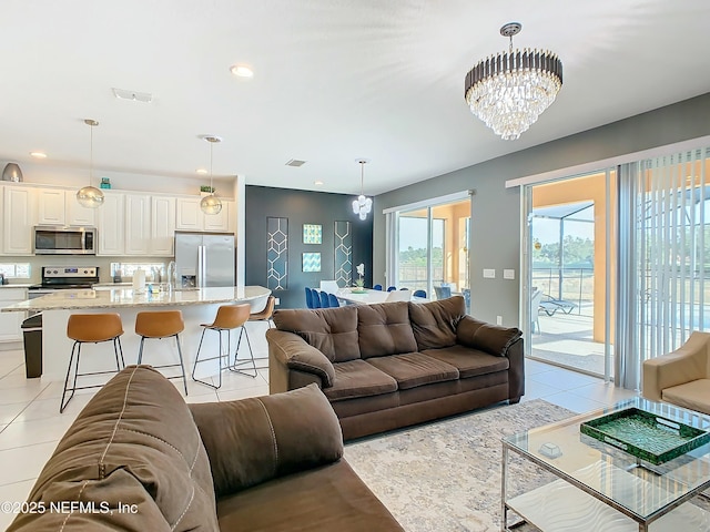 tiled living room featuring a chandelier