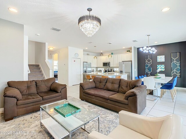 tiled living room featuring a chandelier and sink