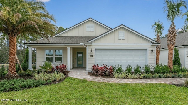 view of front of house featuring a front yard and a garage