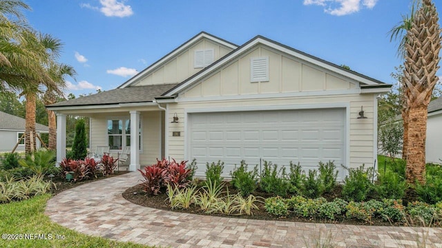 view of front of home with covered porch and a garage