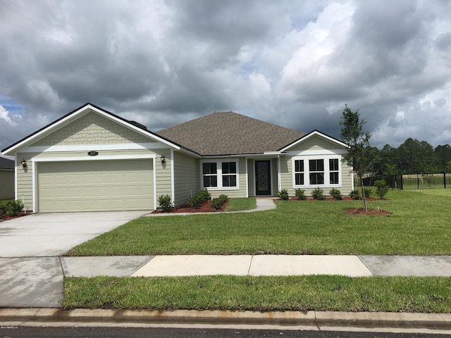 single story home with a front yard and a garage