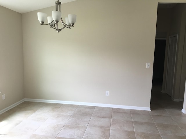 unfurnished room featuring light tile patterned floors and a notable chandelier