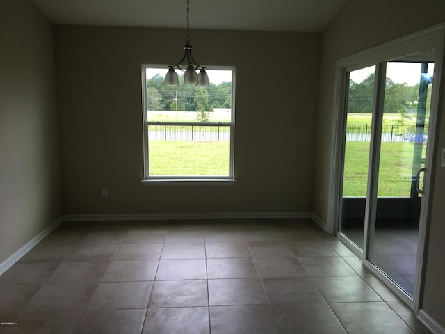 unfurnished dining area featuring vaulted ceiling and tile patterned floors