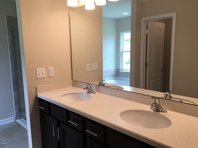 bathroom featuring vanity and separate shower and tub