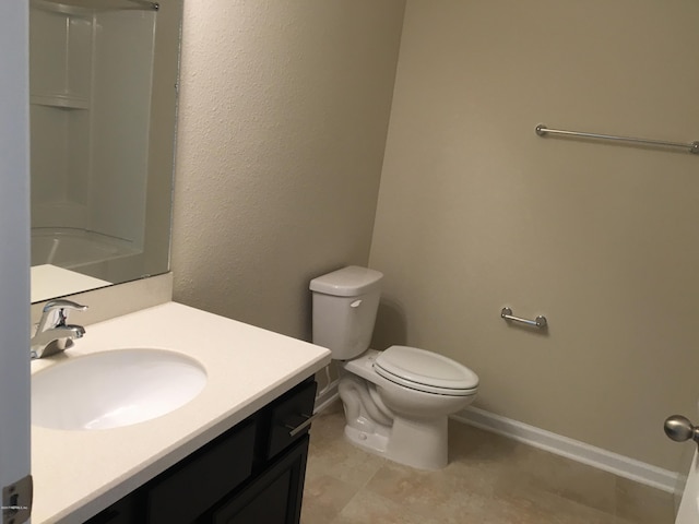 bathroom featuring vanity, toilet, and walk in shower