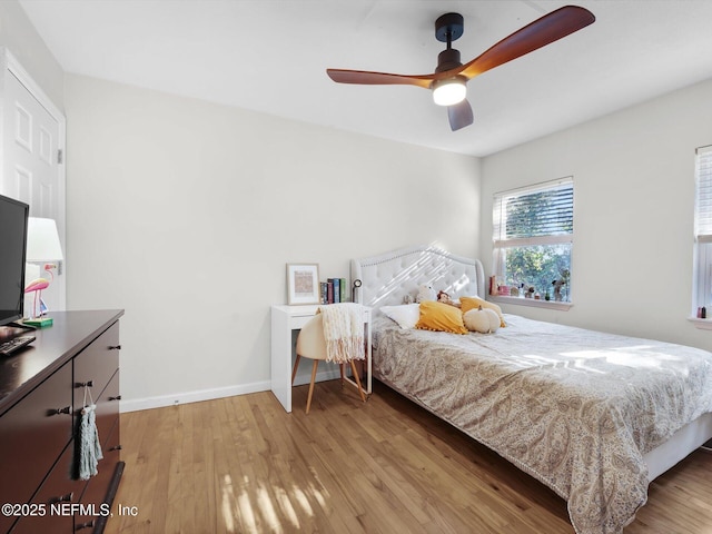 bedroom with ceiling fan and light wood-type flooring