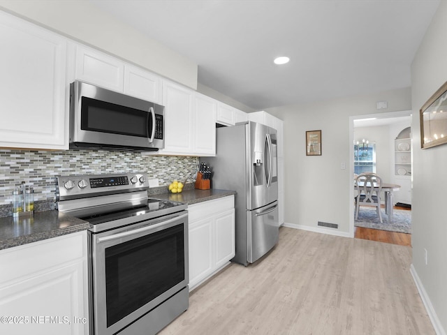 kitchen featuring stainless steel appliances, white cabinets, and light wood-type flooring