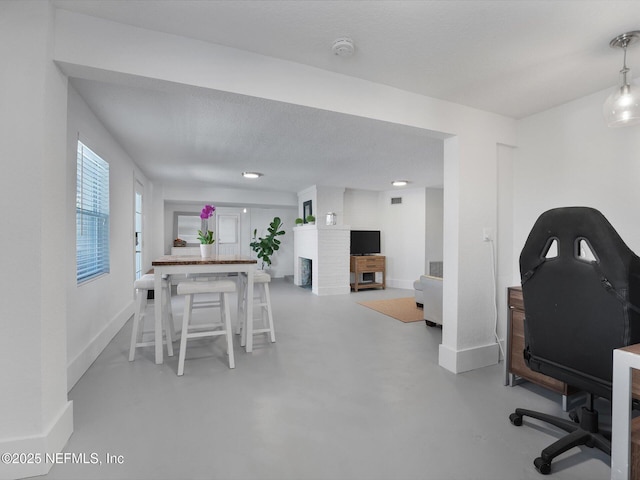 office area with a textured ceiling