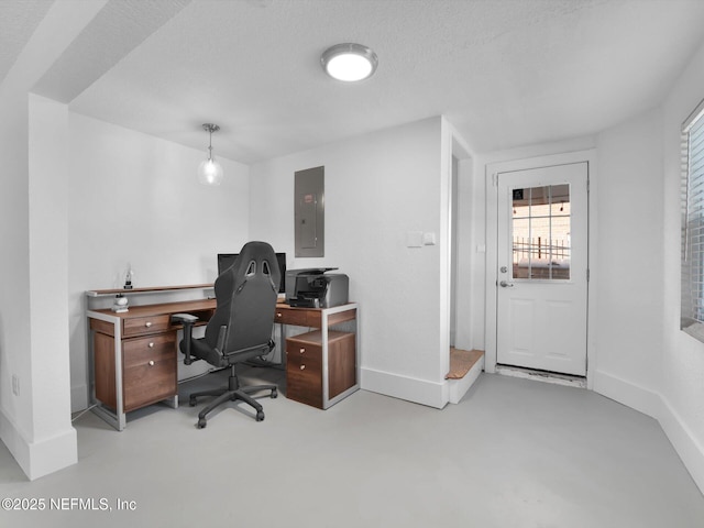 office space with electric panel and a textured ceiling