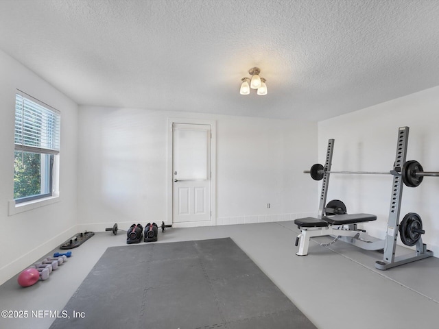 exercise room with a textured ceiling