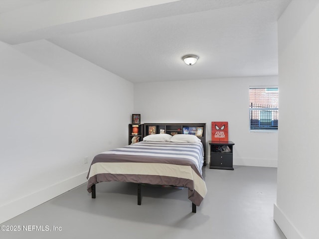 bedroom featuring concrete flooring