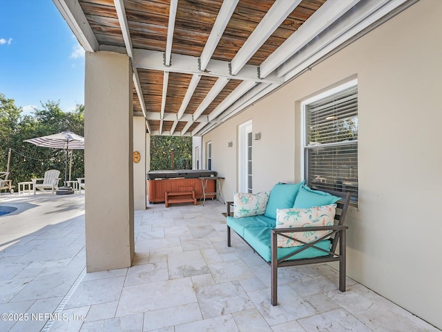 view of patio with a hot tub and an outdoor living space