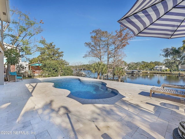 view of pool featuring a patio and a water view