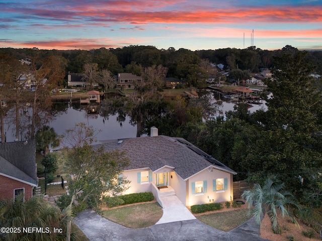 aerial view at dusk with a water view