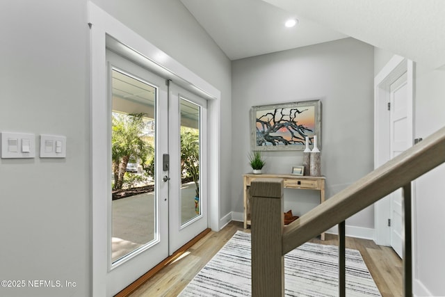 doorway to outside with french doors, light wood-type flooring, recessed lighting, and baseboards