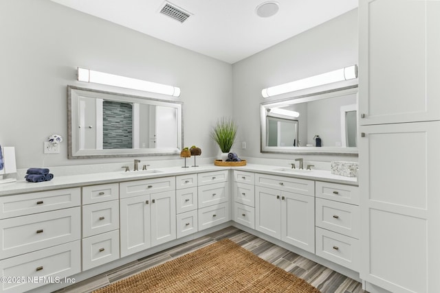 full bath with visible vents, a sink, and double vanity