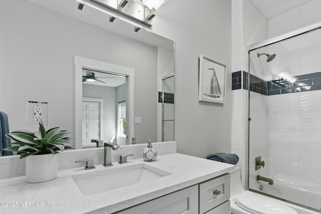 bathroom with toilet, bath / shower combo with glass door, and vanity