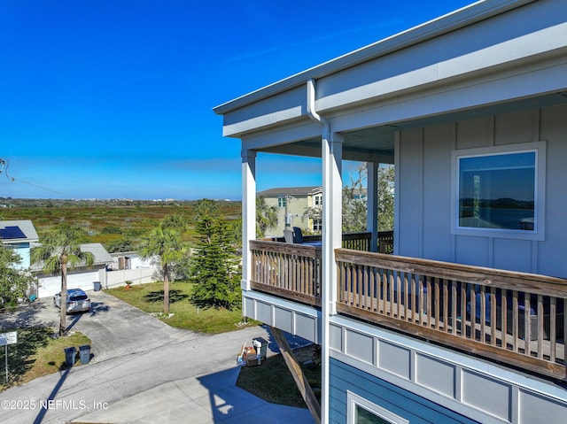 exterior space featuring board and batten siding and a balcony