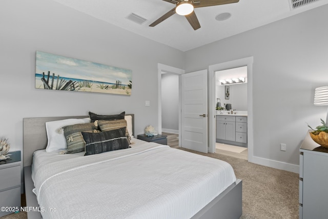 bedroom featuring light colored carpet, visible vents, connected bathroom, and baseboards