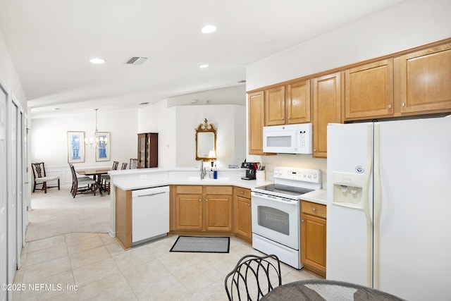 kitchen featuring white appliances, visible vents, a peninsula, light countertops, and a sink