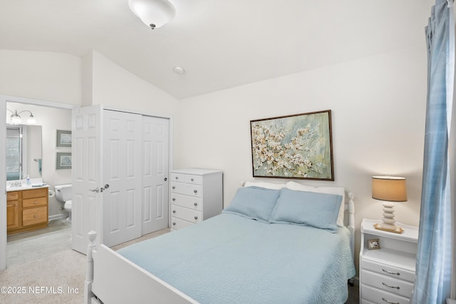 bedroom featuring lofted ceiling, a closet, and connected bathroom