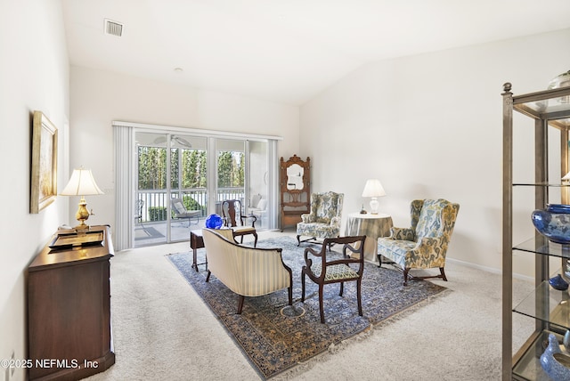 carpeted living room with visible vents, vaulted ceiling, and baseboards