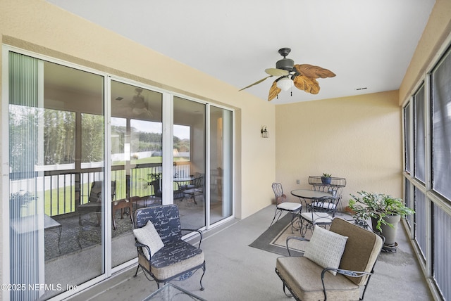 sunroom with visible vents and a ceiling fan