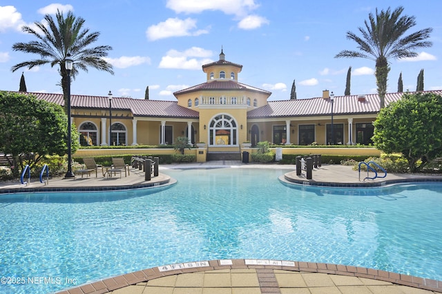 community pool with a patio area