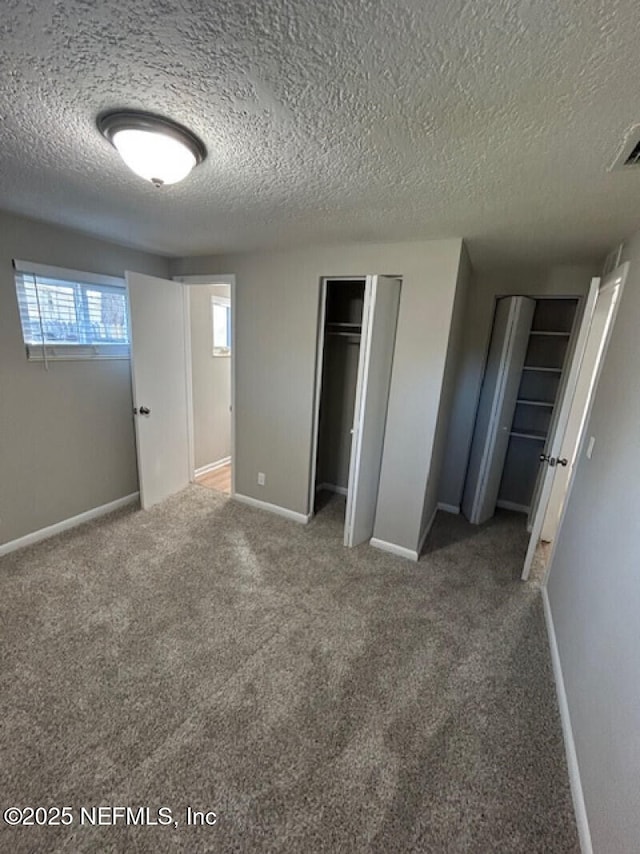 unfurnished bedroom with carpet and a textured ceiling