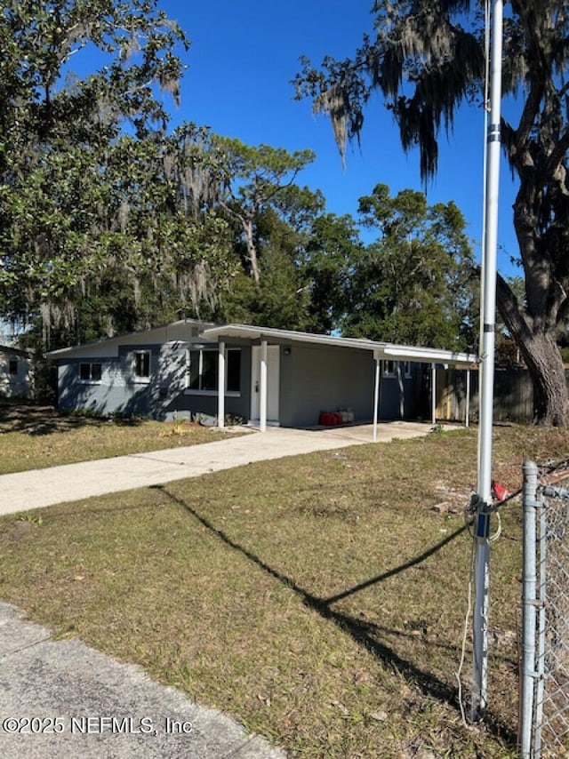 ranch-style house with a carport and a front lawn