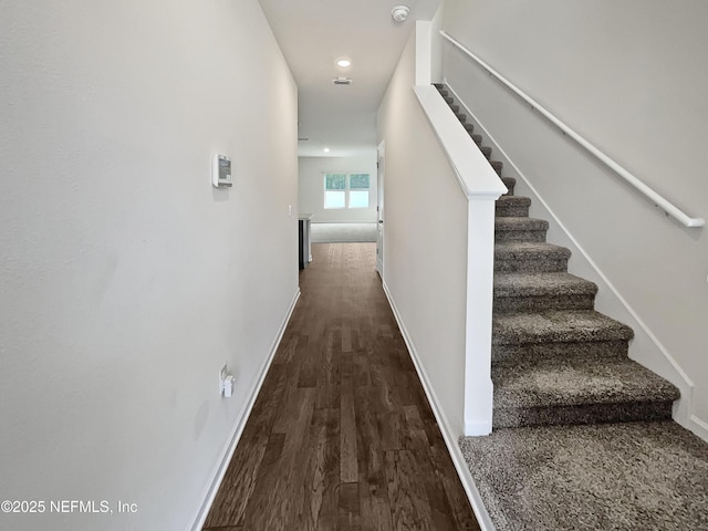 hallway with dark hardwood / wood-style flooring