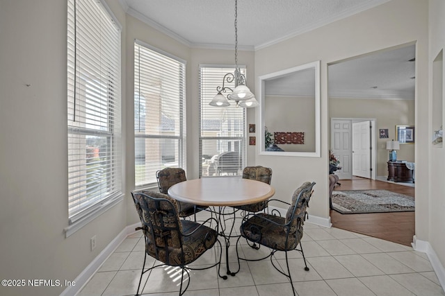 dining space featuring crown molding, plenty of natural light, and light tile patterned flooring