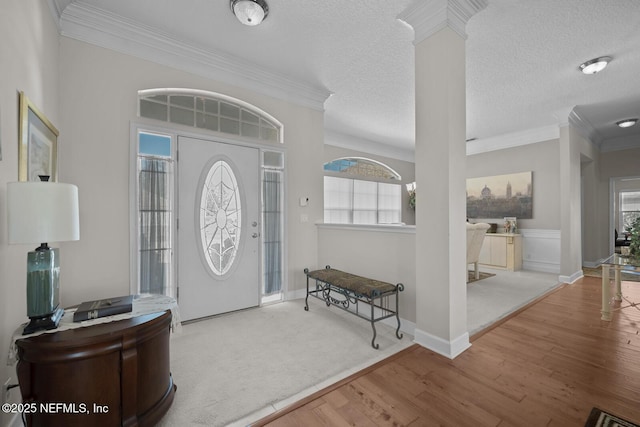 foyer with a wealth of natural light, hardwood / wood-style floors, and a textured ceiling