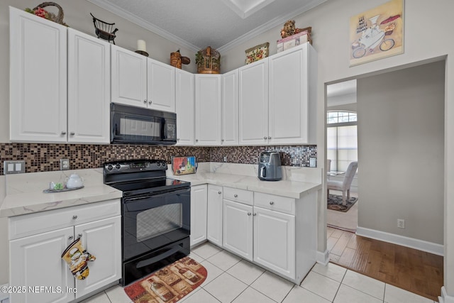 kitchen with decorative backsplash, white cabinets, black appliances, and light tile patterned floors