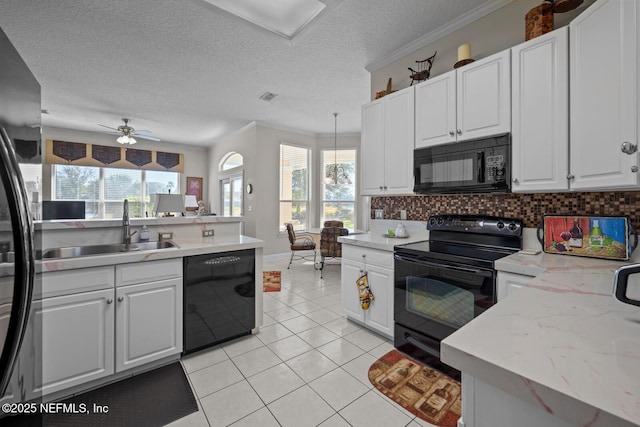 kitchen featuring black appliances, white cabinetry, and sink