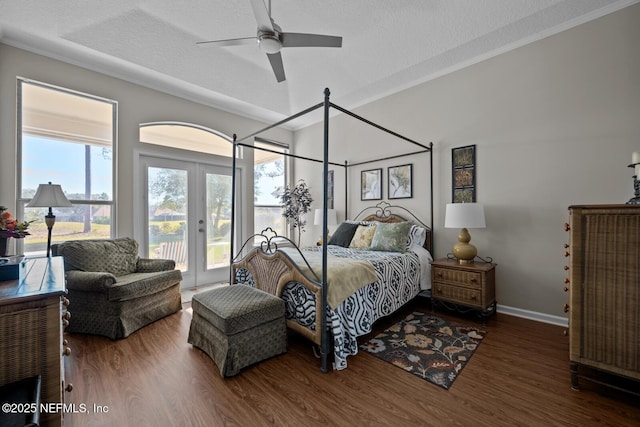 bedroom with ceiling fan, dark wood-type flooring, and a textured ceiling