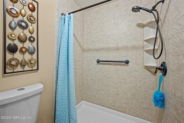 bathroom with a shower with shower curtain and toilet