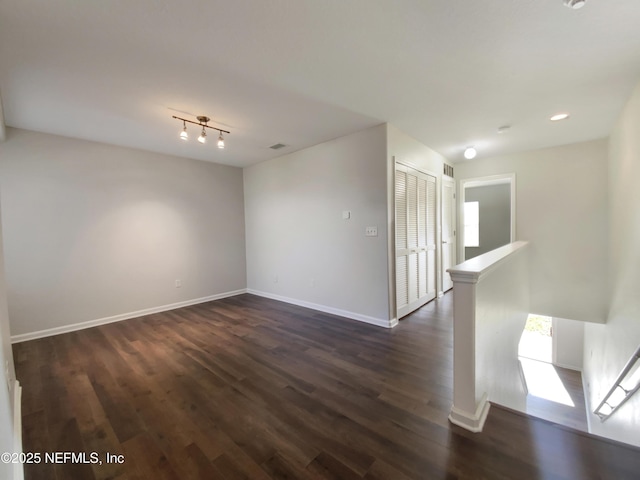 empty room featuring dark wood-type flooring