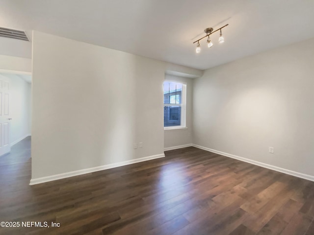 unfurnished room with dark hardwood / wood-style floors