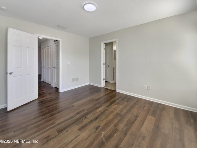 unfurnished bedroom featuring dark wood-type flooring