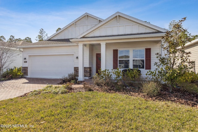 view of front of home with a garage and a front lawn