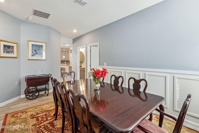 dining room with sink and a textured ceiling