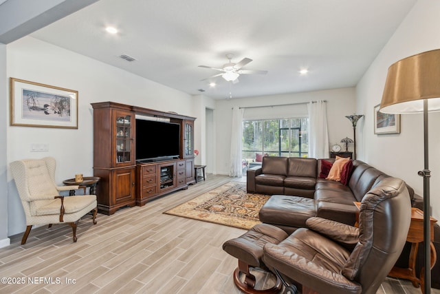 living room with ceiling fan and light hardwood / wood-style floors