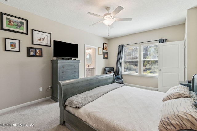 carpeted bedroom with ceiling fan, a textured ceiling, and ensuite bath